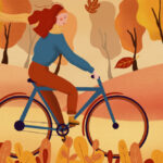 Kvinde cykler om efteråret